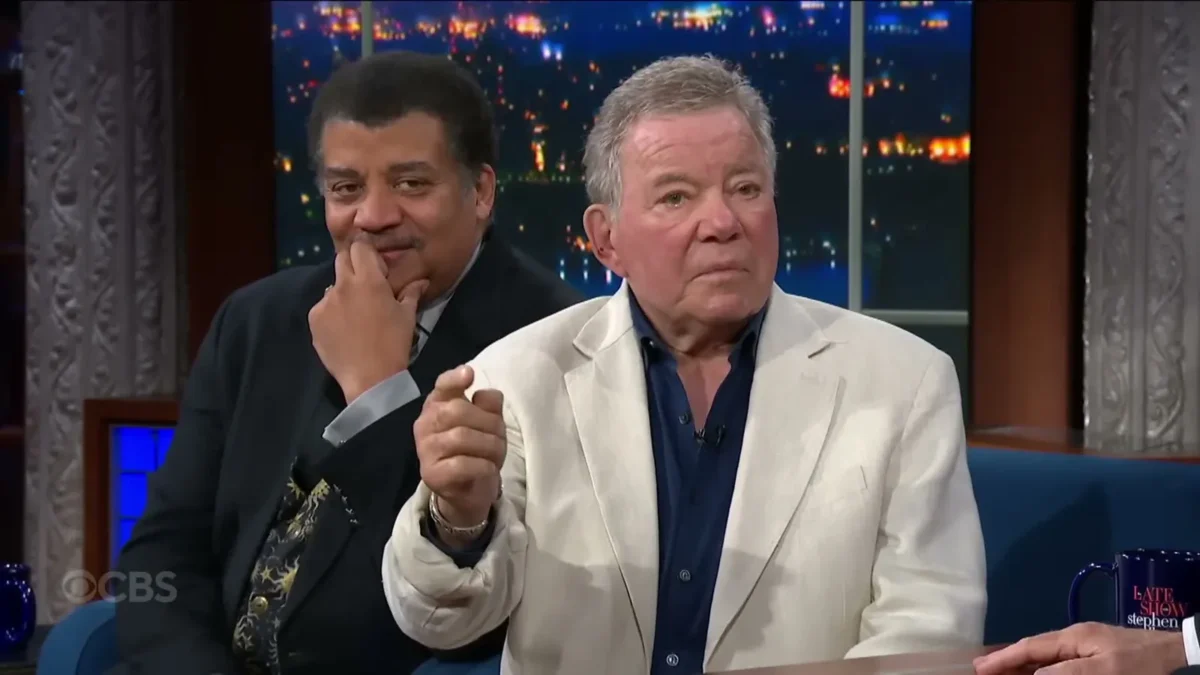 Neil deGrasse Tyson and William Shatner seated side by side on a talk show couch