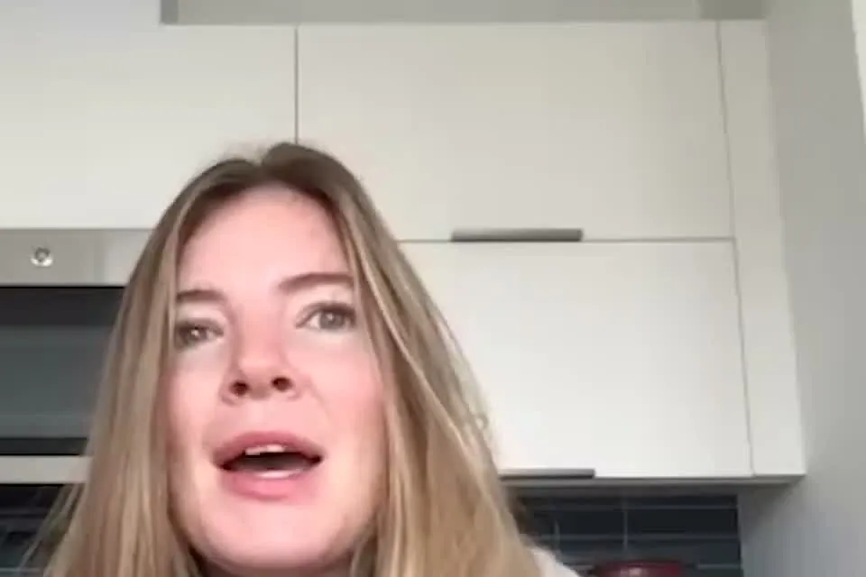 Brooke Eby with long light brown hair speaking to the camera in a kitchen during a video interview