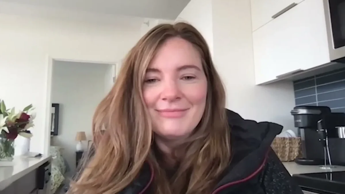 Brooke Eby smiling in a kitchen during a video call for a podcast interview