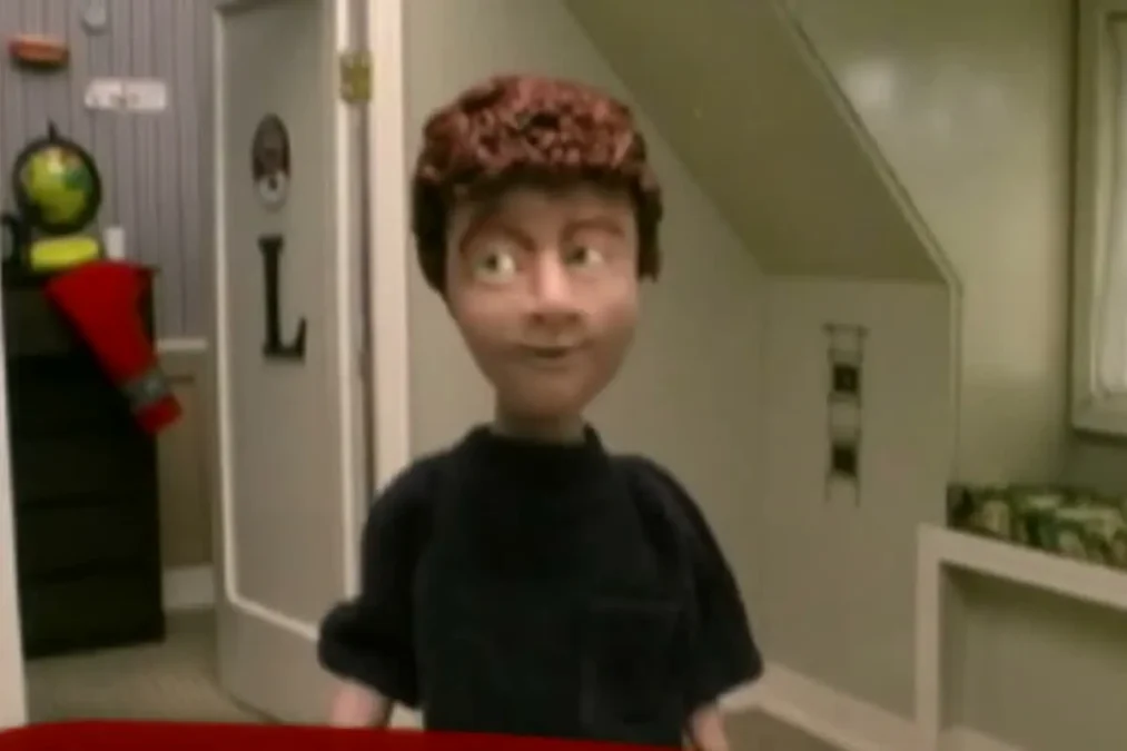 A claymation figure of Louis Stevens in a dark T-shirt with the name Shia LaBeouf on a red banner in the Even Stevens opening credits
