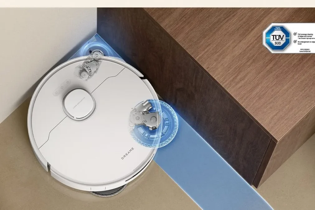 Top view of a white Dreame L40 Ultra Gen 2 robot vacuum pushing its side brush and mop into the corner of a cabinet