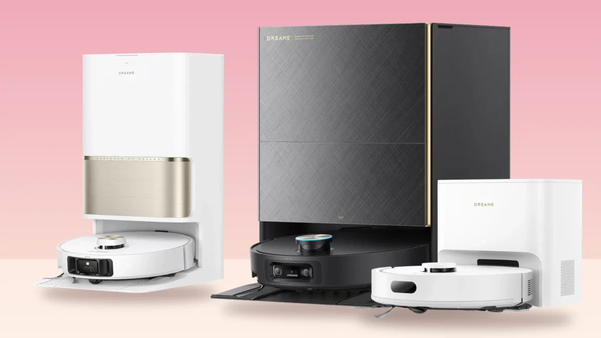 Three Dreame robot vacuums on their docking stations against a pink background: the white-and-gold L60 Ultra PE, the black X60 Max Ultra Complete and the white D20 Air Plus