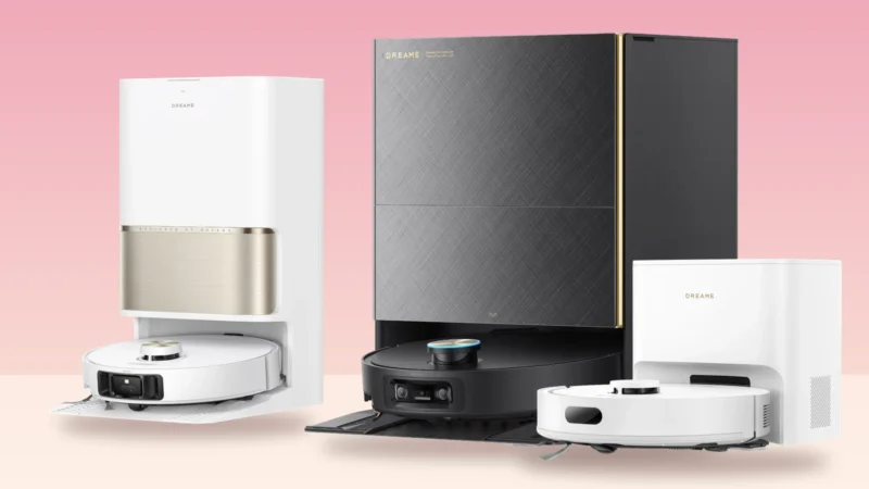 Three Dreame robot vacuums on their docking stations against a pink background: the white-and-gold L60 Ultra PE, the black X60 Max Ultra Complete and the white D20 Air Plus