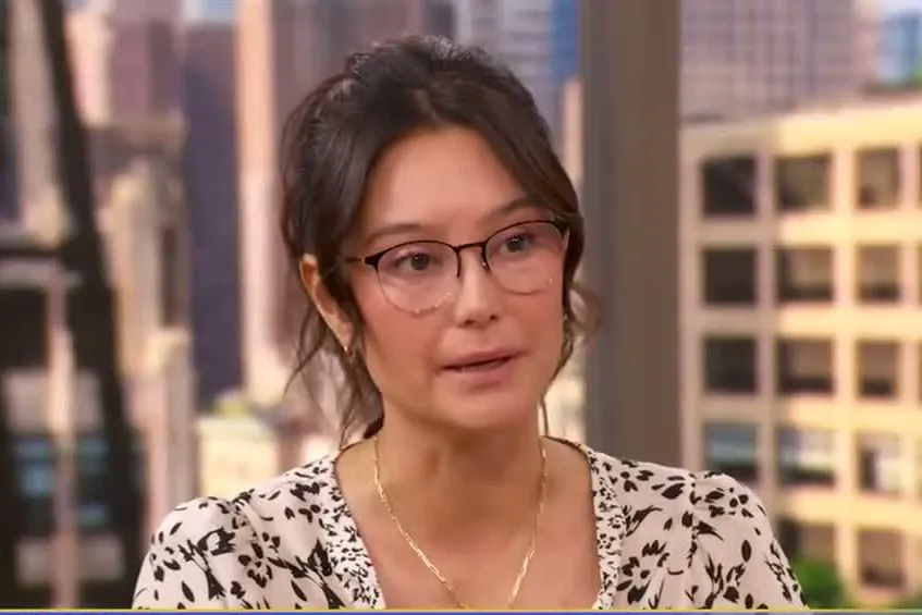 Emma Heming Willis with her hair pulled back and glasses, in a leopard-print top, on the Good Morning America set