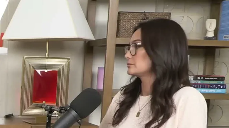 Emma Heming Willis in a cream sweater, in profile, during a podcast interview