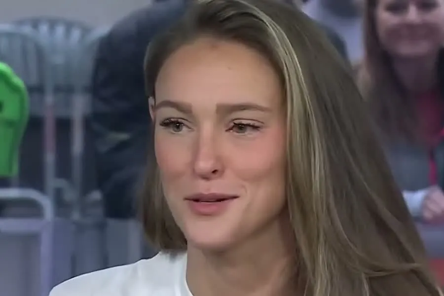 Kylie Kelce with long highlighted hair and a white top smiling on the TODAY set