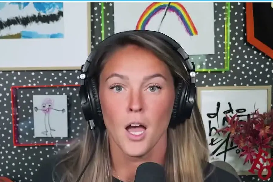 Kylie Kelce with long highlighted hair and headphones talking on the Not Gonna Lie set