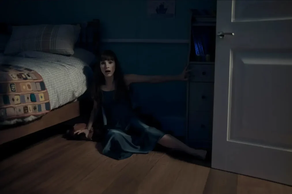 Jessica Chastain sprawled on the floor of a child's bedroom next to the bed