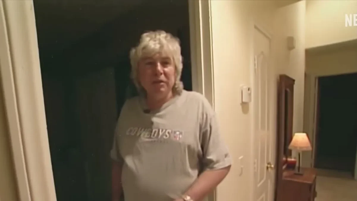 Thomas Randolph in a gray Cowboys T-shirt standing in a hallway of his Las Vegas home at night
